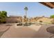 Backyard pool with rock feature and a tall palm tree, perfect for outdoor fun and relaxation at 3234 E Marco Polo Rd, Phoenix, AZ 85050
