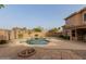 Backyard oasis featuring a pool, patio with a fire pit, and desert landscaping, ideal for relaxation at 3234 E Marco Polo Rd, Phoenix, AZ 85050