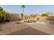 Backyard pool with rock feature, palm tree and stone patio area for entertaining at 3234 E Marco Polo Rd, Phoenix, AZ 85050