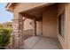Inviting front porch with stone pillars and a cozy, covered entrance at 3234 E Marco Polo Rd, Phoenix, AZ 85050