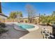 Backyard oasis with a pool, desert landscaping, spa, string lights, and privacy at 328 W Dragon Tree Ave, San Tan Valley, AZ 85140