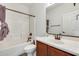 Bright bathroom featuring a shower-tub combo, vanity with sink, and bronze fixtures at 328 W Dragon Tree Ave, San Tan Valley, AZ 85140