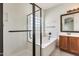 Bathroom featuring a soaking tub with a glass shower enclosure and a vanity with modern fixtures at 328 W Dragon Tree Ave, San Tan Valley, AZ 85140