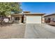 Charming single-story home featuring a well-manicured front yard and an attached two-car garage at 328 W Dragon Tree Ave, San Tan Valley, AZ 85140