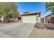 Charming single-story home featuring a well-manicured front yard and an attached two-car garage at 328 W Dragon Tree Ave, San Tan Valley, AZ 85140