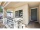 Inviting covered front porch with a gray front door and a charming railing at 328 W Dragon Tree Ave, San Tan Valley, AZ 85140