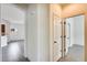 Hallway with tile flooring, an arched entryway, and doors leading to various rooms at 328 W Dragon Tree Ave, San Tan Valley, AZ 85140