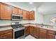 Kitchen featuring wood cabinets, stainless steel appliances, and updated countertops at 328 W Dragon Tree Ave, San Tan Valley, AZ 85140