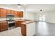 Open concept kitchen with stainless steel appliances, breakfast bar, and tile flooring at 328 W Dragon Tree Ave, San Tan Valley, AZ 85140