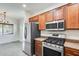 Kitchen with stainless steel appliances and adjacent dining area at 328 W Dragon Tree Ave, San Tan Valley, AZ 85140