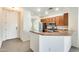Open-concept kitchen with a breakfast bar, stainless steel appliances, and tile flooring at 328 W Dragon Tree Ave, San Tan Valley, AZ 85140