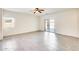 Spacious living room with modern tile flooring, a ceiling fan, and sliding glass doors at 328 W Dragon Tree Ave, San Tan Valley, AZ 85140