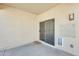 Enclosed patio area featuring a sliding door, pet door, and exterior light fixture at 328 W Dragon Tree Ave, San Tan Valley, AZ 85140