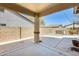 Covered patio view revealing a spa behind a block wall and a glimpse of the swimming pool at 328 W Dragon Tree Ave, San Tan Valley, AZ 85140