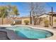 Inviting backyard pool with desert landscaping, spa and hardscape surround at 328 W Dragon Tree Ave, San Tan Valley, AZ 85140