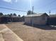 Backyard with gravel landscaping, a wooden fence, and a small storage shed at 3307 W Ocotillo Rd, Phoenix, AZ 85017