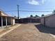Spacious backyard featuring gravel landscaping, a wood fence, and two storage sheds at 3307 W Ocotillo Rd, Phoenix, AZ 85017