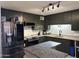 Updated kitchen showcasing stainless steel appliances, ample cabinet space, and granite countertops at 3307 W Ocotillo Rd, Phoenix, AZ 85017
