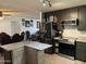 Open kitchen with stainless steel appliances and island with a view into an adjacent living room at 3307 W Ocotillo Rd, Phoenix, AZ 85017