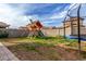 Wide shot of a large backyard with play structure and trampoline at 3522 E Spring Wheat Ln, Gilbert, AZ 85296