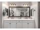 Bathroom featuring double sinks, a large mirror, and ample counter space at 3522 E Spring Wheat Ln, Gilbert, AZ 85296