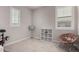 Cozy bedroom featuring two windows, a chair, and a floor lamp at 3522 E Spring Wheat Ln, Gilbert, AZ 85296