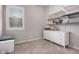 Neutral bedroom with white dresser and built-in shelving; window with plantation shutters at 3522 E Spring Wheat Ln, Gilbert, AZ 85296