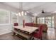Bright dining area features a table with red chairs and a bench, with natural light at 3522 E Spring Wheat Ln, Gilbert, AZ 85296