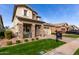 Attractive home with a stone-accented facade, well-kept lawn, and a brick-paved driveway at 3522 E Spring Wheat Ln, Gilbert, AZ 85296