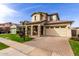 Beautiful two-story home featuring a manicured lawn and a brick paved driveway at 3522 E Spring Wheat Ln, Gilbert, AZ 85296