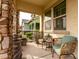 Inviting front porch with stone columns and comfortable seating, perfect for relaxing at 3522 E Spring Wheat Ln, Gilbert, AZ 85296