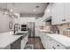 Spacious kitchen boasts white cabinets, stainless steel appliances, and decorative tile backsplash at 3522 E Spring Wheat Ln, Gilbert, AZ 85296