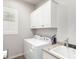 Bright laundry room with white cabinets, modern washer and dryer and utility sink at 3522 E Spring Wheat Ln, Gilbert, AZ 85296