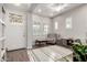 Bright living room with wood floors, white trim, and many windows at 3522 E Spring Wheat Ln, Gilbert, AZ 85296