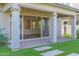 Covered back patio with brick pavers and artificial grass at 3830 E Appaloosa Rd, Gilbert, AZ 85296