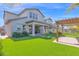 Expansive backyard with artificial grass, covered patio, and pergola at 3830 E Appaloosa Rd, Gilbert, AZ 85296