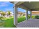 Covered back patio overlooking artificial grass, pavers, and a pergola at 3830 E Appaloosa Rd, Gilbert, AZ 85296