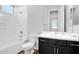 Bright bathroom with a shower-tub, dark vanity and white countertop at 3830 E Appaloosa Rd, Gilbert, AZ 85296