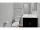 Bathroom features a vanity with a black cabinet, a toilet and a mirror at 3830 E Appaloosa Rd, Gilbert, AZ 85296