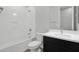 Clean, well-lit bathroom featuring a shower/tub and vanity with dark cabinets at 3830 E Appaloosa Rd, Gilbert, AZ 85296
