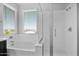 Bright bathroom with a soaking tub and glass enclosed shower with seat at 3830 E Appaloosa Rd, Gilbert, AZ 85296