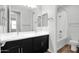 Bathroom featuring dual sinks, dark cabinets, and a shower-tub combo at 3830 E Appaloosa Rd, Gilbert, AZ 85296