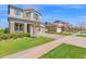An attractive two-story home with stone accents, a paved driveway, green lawns, and mature trees in a suburban neighborhood at 3830 E Appaloosa Rd, Gilbert, AZ 85296