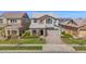 Inviting two-story home with stone accents, a two-car garage, a brick driveway, and a landscaped front yard at 3830 E Appaloosa Rd, Gilbert, AZ 85296