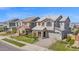A stylish two-story home featuring stone details, a paved driveway, and a well-maintained lawn in a residential neighborhood at 3830 E Appaloosa Rd, Gilbert, AZ 85296