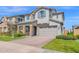Beautiful two-story home featuring stone accents, a brick driveway, and a well-manicured lawn at 3830 E Appaloosa Rd, Gilbert, AZ 85296