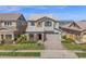 Charming two-story home featuring stone accents, a well-maintained lawn, and a spacious two car garage at 3830 E Appaloosa Rd, Gilbert, AZ 85296