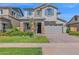 Charming two-story home with a manicured lawn, stone accents, and a two-car garage at 3830 E Appaloosa Rd, Gilbert, AZ 85296