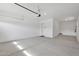 Spacious garage with concrete floors and a white interior door at 3830 E Appaloosa Rd, Gilbert, AZ 85296