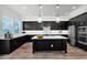 Modern kitchen with stainless steel appliances, dark cabinets, and quartz countertops at 3830 E Appaloosa Rd, Gilbert, AZ 85296